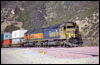 SD45-2 5857 and H1 SD40-2 6954 help an eastbound at Cajon, CA, 2000