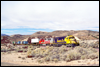 SD40-2 5045 and GP60M 109 assist a train descending Cajon Pass about a mile west of Summit, CA, 1994