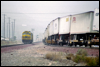 SDF40-2 5265 • Santa Fe helpers drift down the South Track while an eastbound TOFC hustles up the North Track at Cajon, CA, 1995