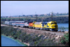On April 23, 1987, an Operation Lifesaver special rolls across a fill through the Batiquitos Lagoon in Carlsbad as the train makes its way toward San Diego. Santa Fe FP45 5998 pilots Union Pacific E9 951, Southern Pacific SDP45 3201, Amtrak F40PH 240 and a mix of passenger cars.