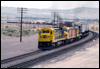 C30-7 8065 leads a westbound intermodal accelerates out of the Barstow yard at Valley Jct, CA, 1988