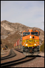 BNSF 5087 eases a stack train into the curve at Cozy Dell, CA, in Cajon Pass, 2006