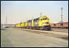 A mix of six EMD and GE 4-axle units are on the head end of an eastbound manifest. GP35 2836 leads through A-yard, San Bernardino, CA, 1991
