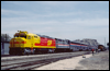 SPSF merger painted FP45 5998 leading an Amtrak F40PH and Superliner cars pauses at Victorville, CA, on April 12, 1986. This train ran between Los Angeles and Barstow, CA, as part of a celebration commemorating 100 years of service on the mainline through Cajon Pass.